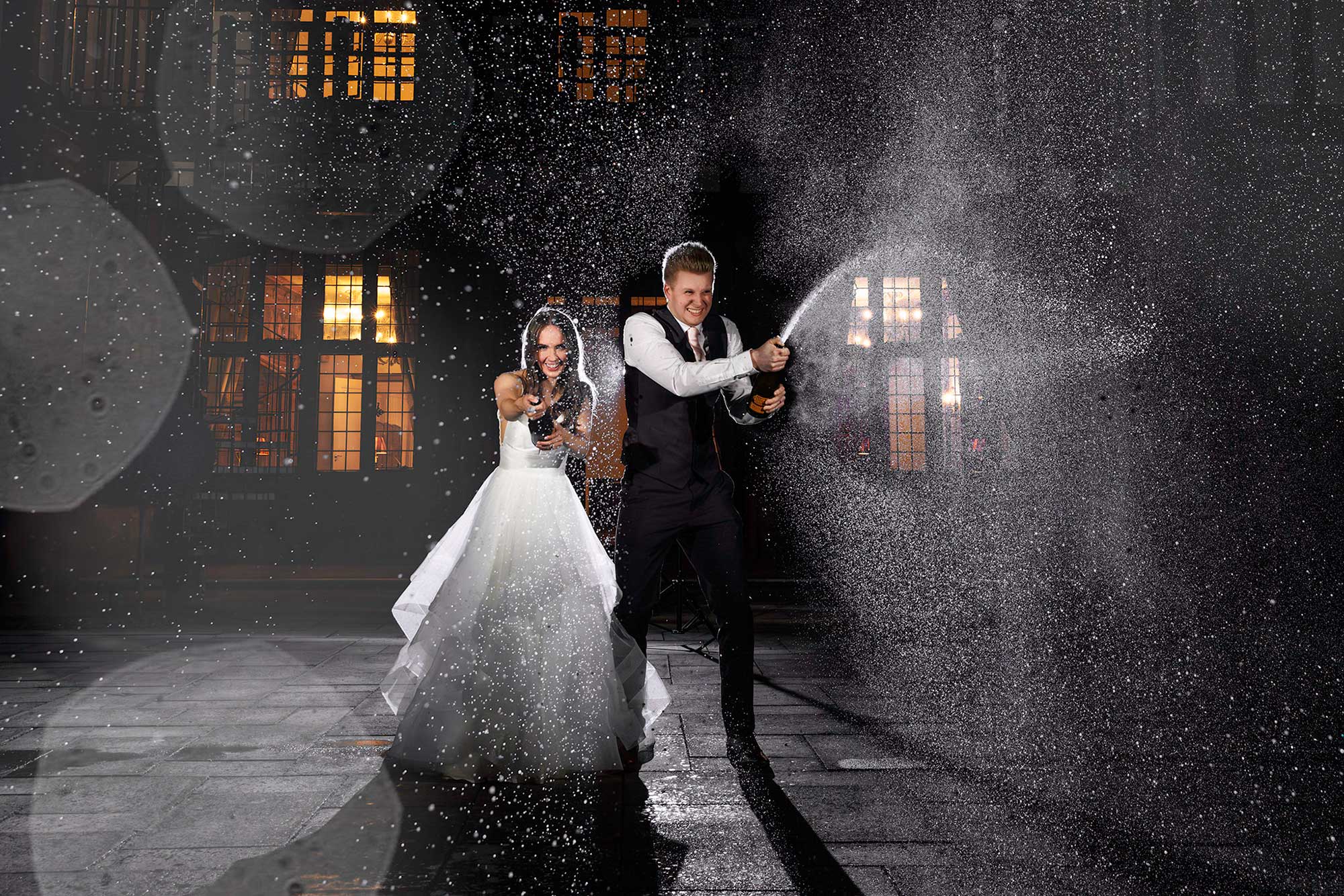 Bride and Groom Spraying champagne 