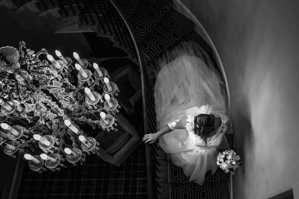 Bride walking down the stairs at Rosset Hall on her way to get married