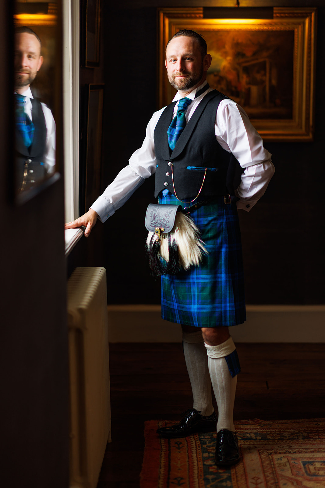 Groom portrait in window light at Iscoyd Park, North Wales