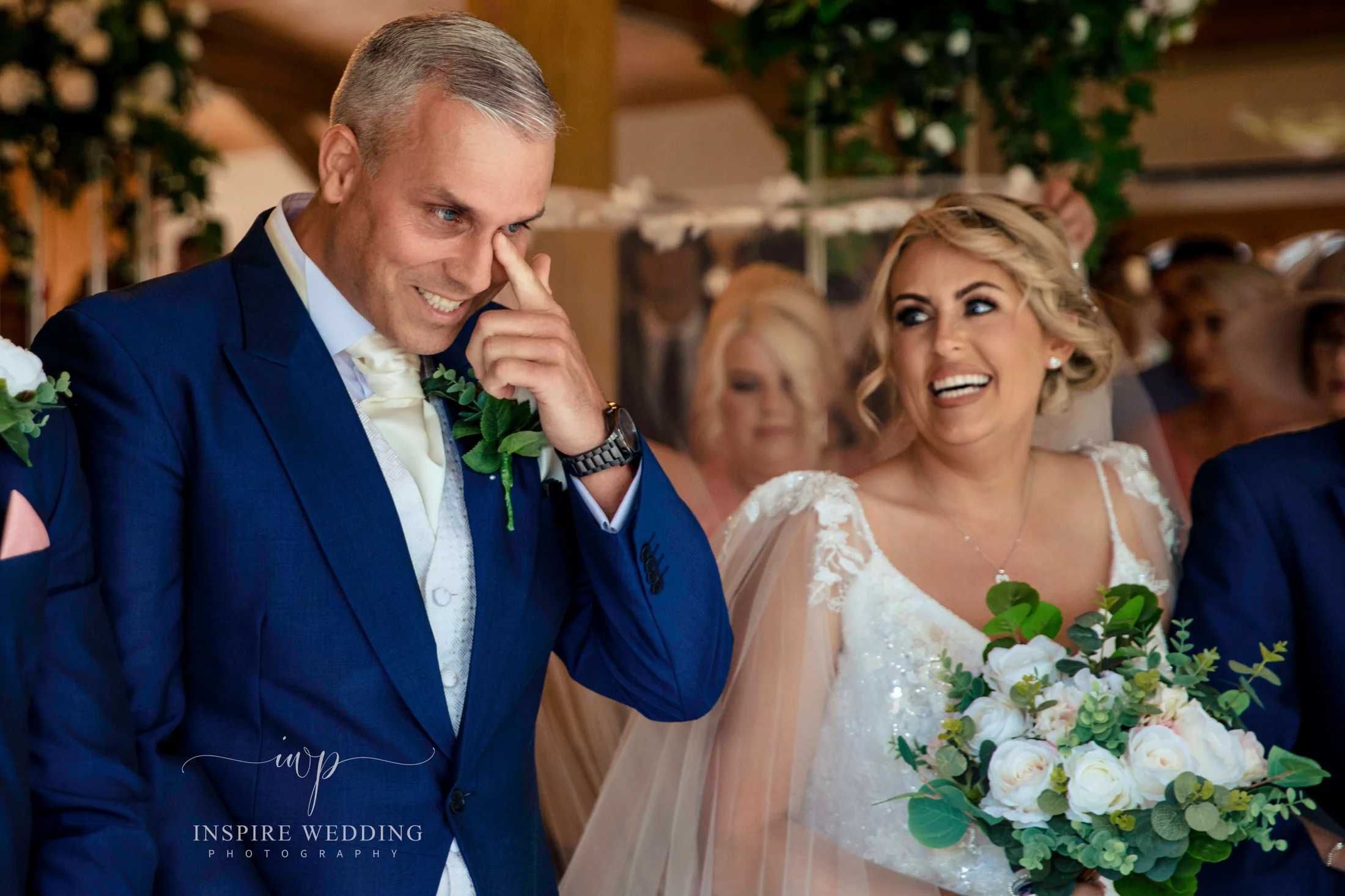 A groom wiping away a tear during his Cheshire wedding at Colshaw Hall