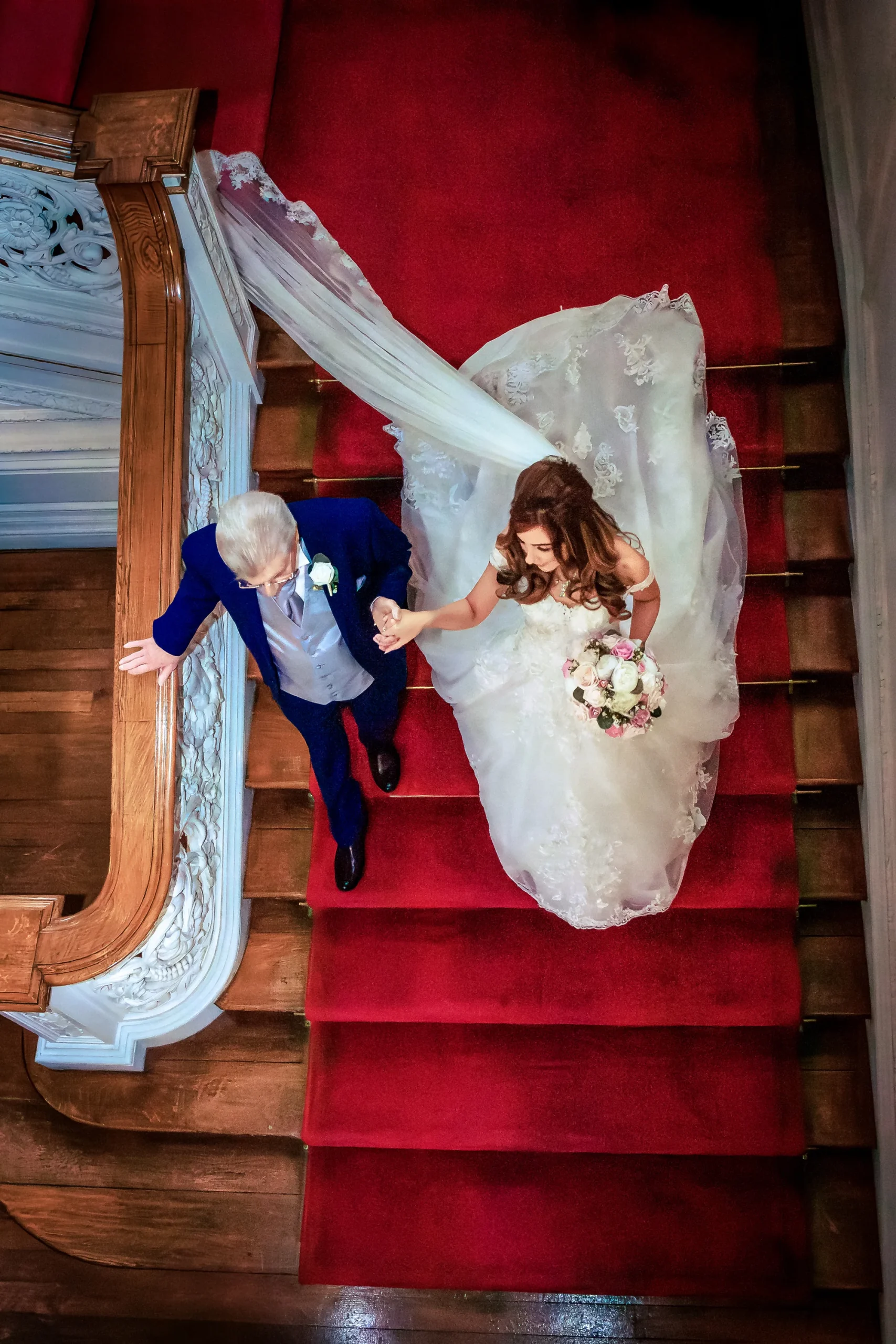 Bride and father descend the staircase at Knowsley Hall