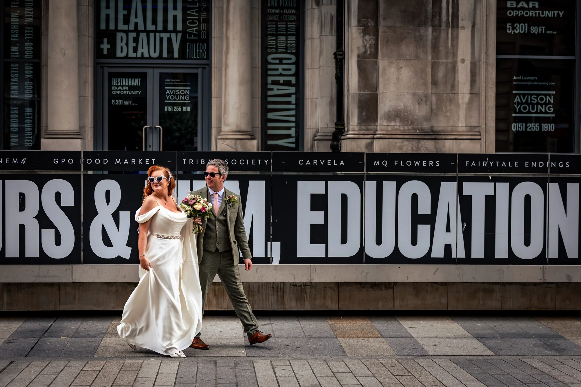 Newlyweds walking through Liverpool city centre