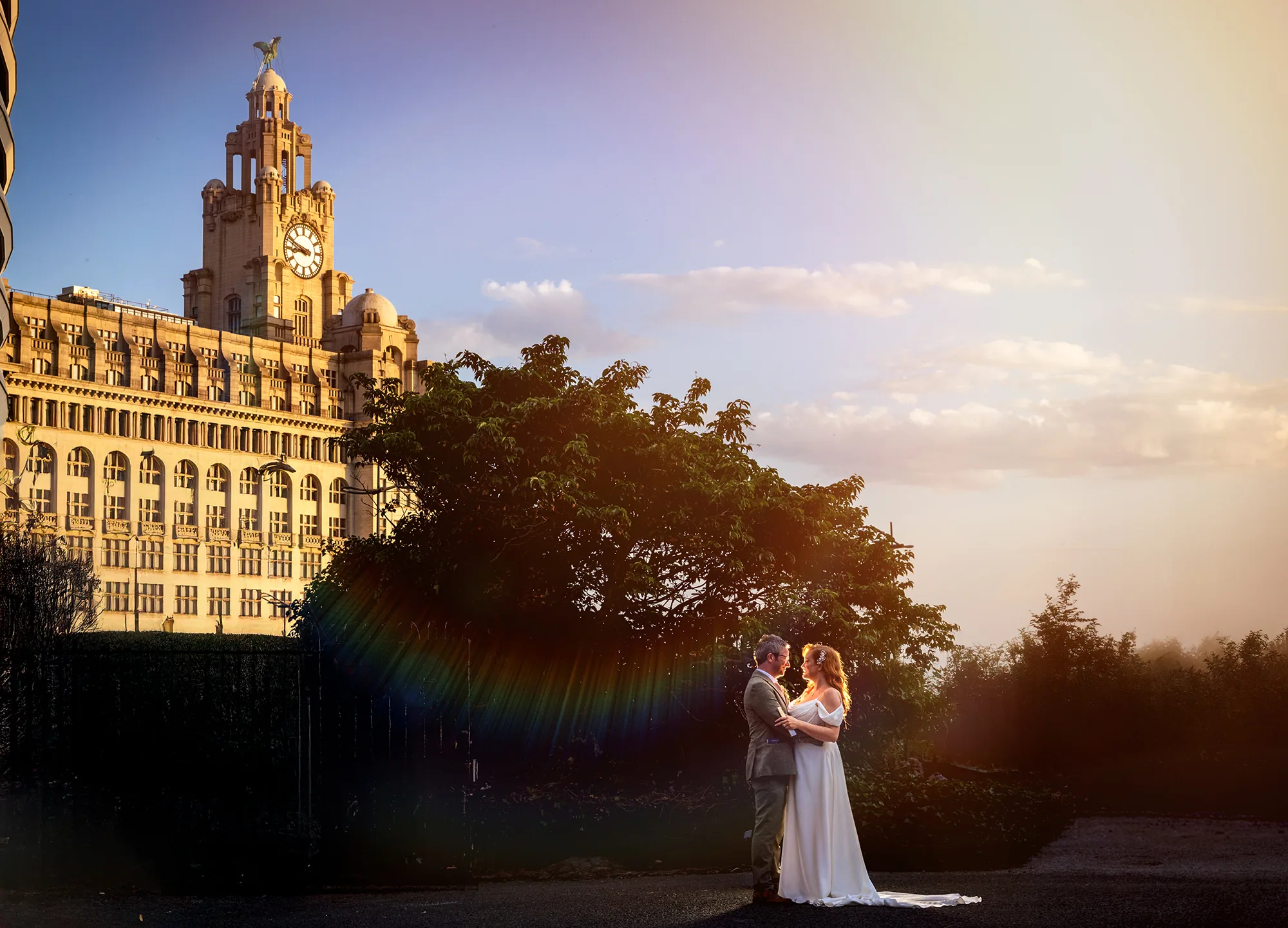 Wedding couple at sunset beside Liverpool's Royal Liver Building