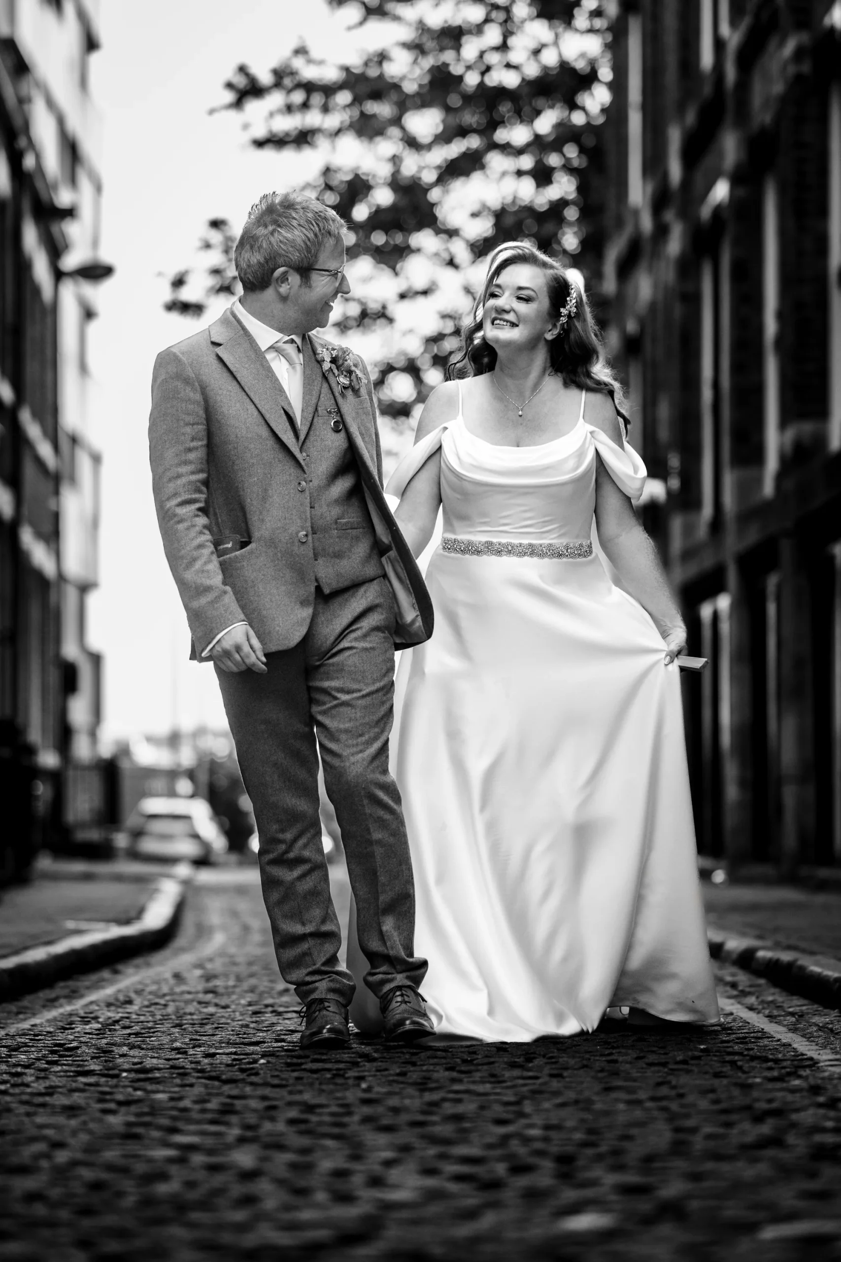Bride and groom walking together on a Liverpool street