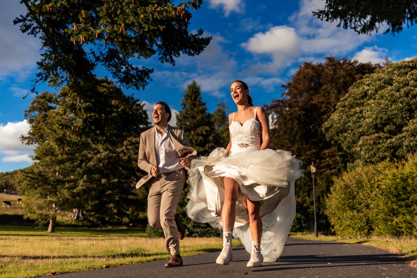 Newlyweds laughing as they run together outdoors in the North West